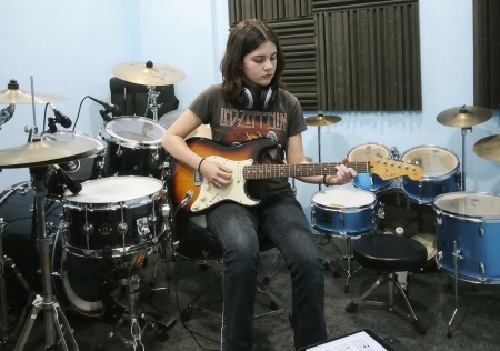 Teenager playing electric guitar